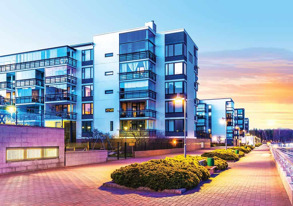 Modern apartment complex at sunset showcasing the future of property management